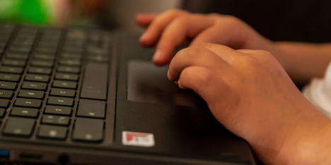 A close up of hands on a computer